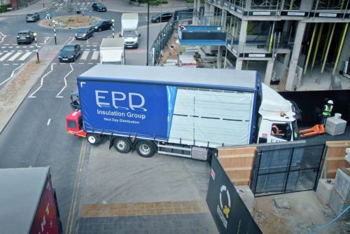 EPD truck delivering at urban construction site.