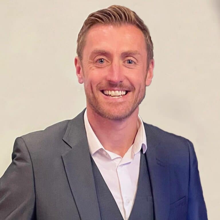 Smiling man in suit for professional profile picture.