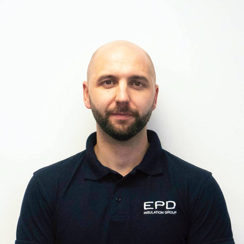 Bald man in EPD uniform against white background.