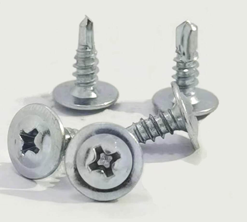 Four metal screws on white background